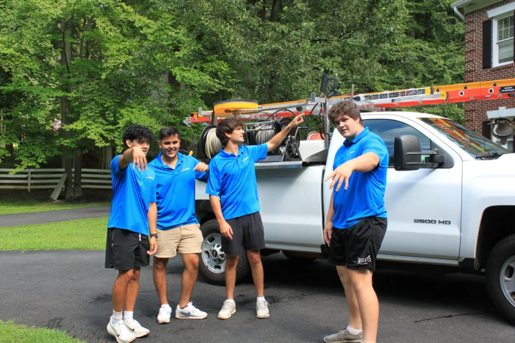 AllPro crew planning a job beside their work truck in a homeowner's driveway